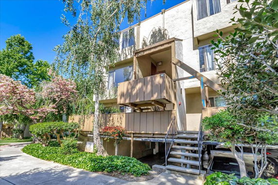 Front view of a multi-story residential building with balconies.