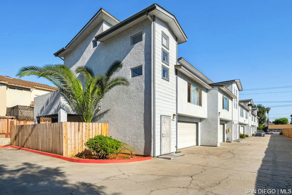 Front view of a multi-story residential building with garages.
