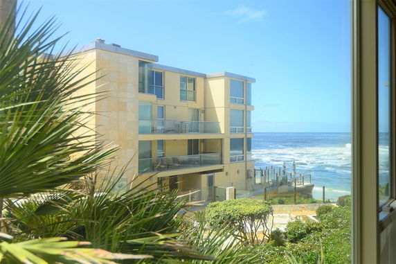Front view of a multi-story beachfront building.