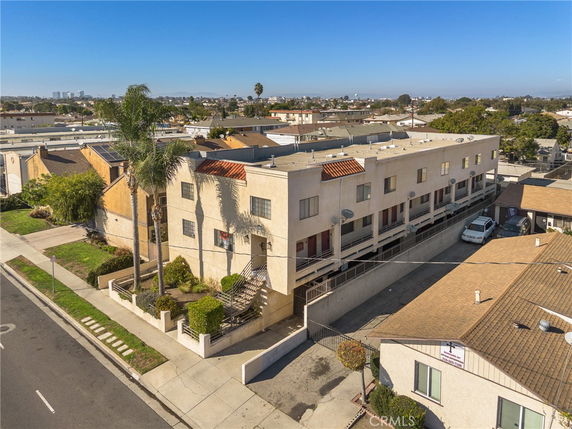 Front view of a multi-story apartment building with balconies.