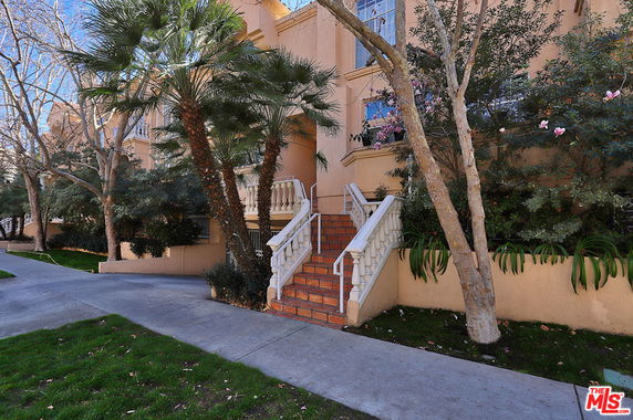 Front view of a multi-story building with a staircase and entrance.