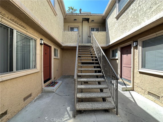 Front view of a building section with stairs leading to upper level.