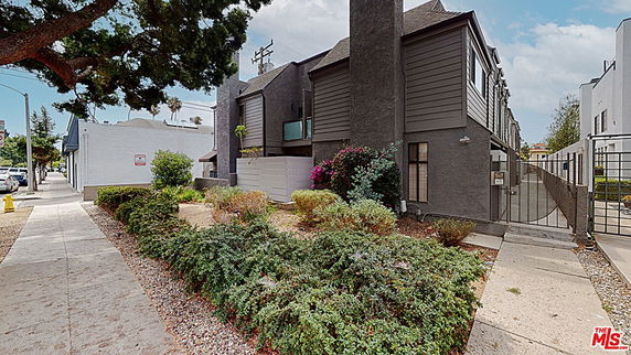 Front view of a multi-story building with modern architecture and landscaped surroundings.