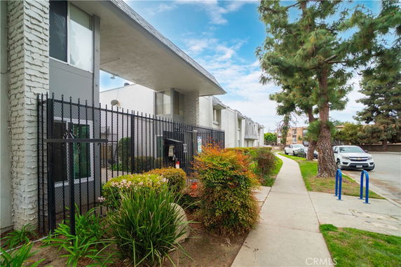 Front view of a multi-story building with a gated entrance.