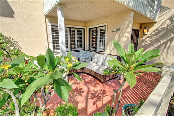 Front view of a house with a small patio area and plants.
