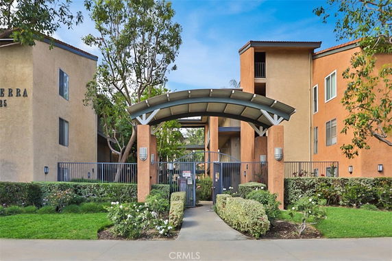 Front view of a multi-story building with an arched entryway.