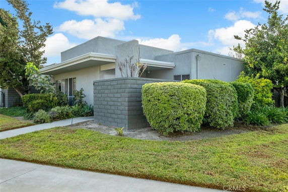 Front view of a modern single-story house with a flat roof and large windows.