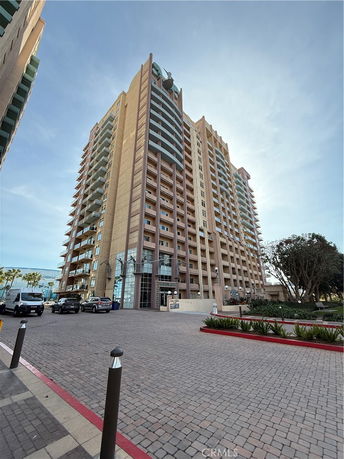 Front view of a multi-story building with balconies.