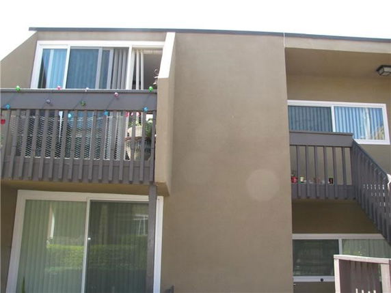 Front view of a two-story building with balconies.