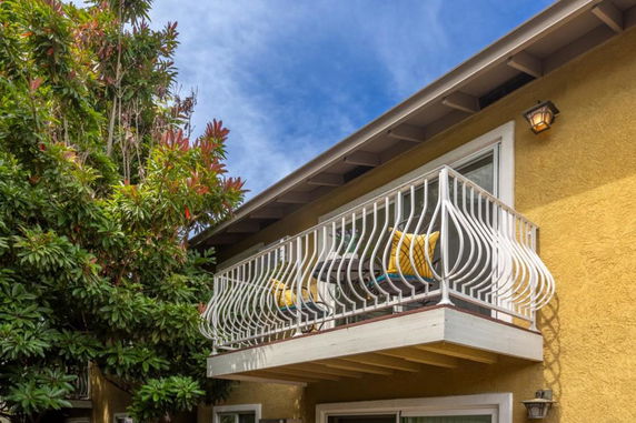 Front view of a house with a small balcony and decorative railing.