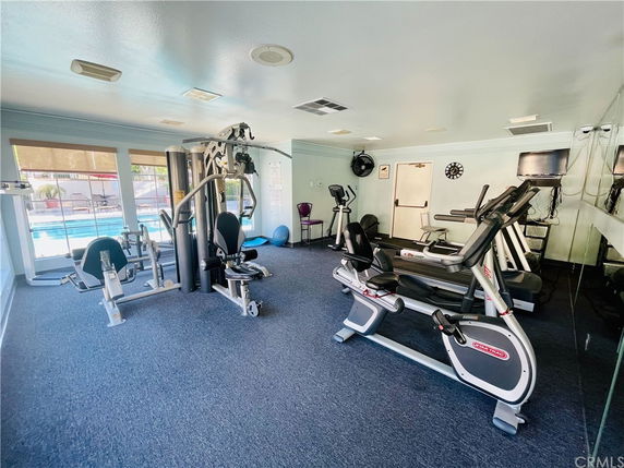 Interior view of a gym room with exercise equipment in a recreational facility.