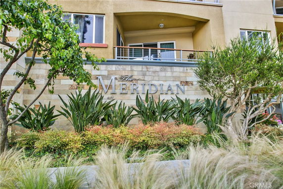 Front view of a residential building with the name 'The Meridian' on the facade.