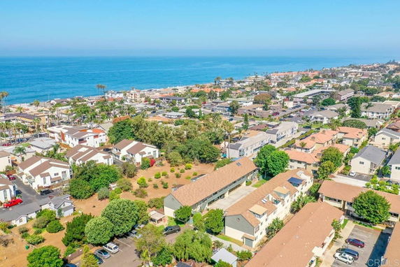 Aerial view of a coastal residential area with multiple houses and proximity to the ocean.