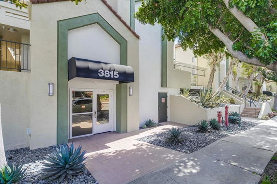 Front view of a building entrance with the number 3815 on an awning.