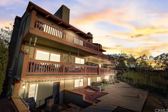 Front view of a multi-story building with extended balconies and a pathway.