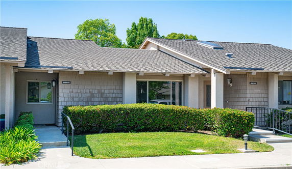Front view of a single-story house with an entrance walkway and front porch.