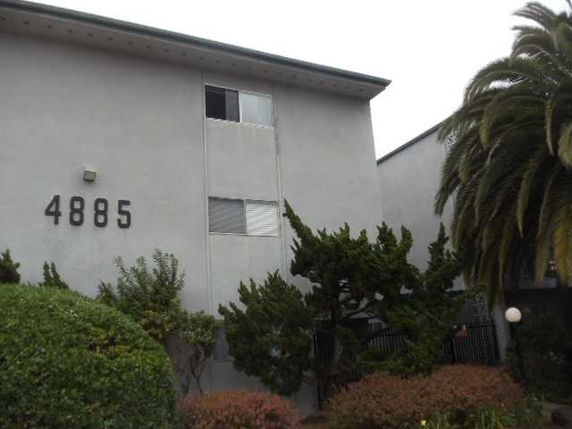 Front view of a multi-story building with number 4885 on the facade.