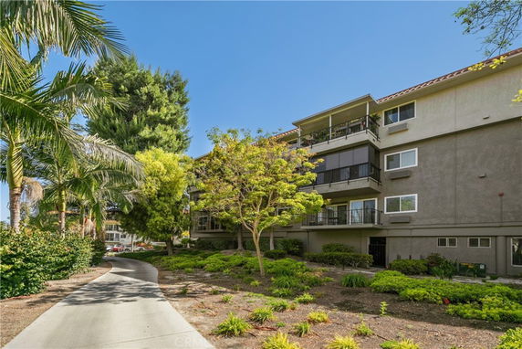 Front view of a multi-story apartment building with balconies.