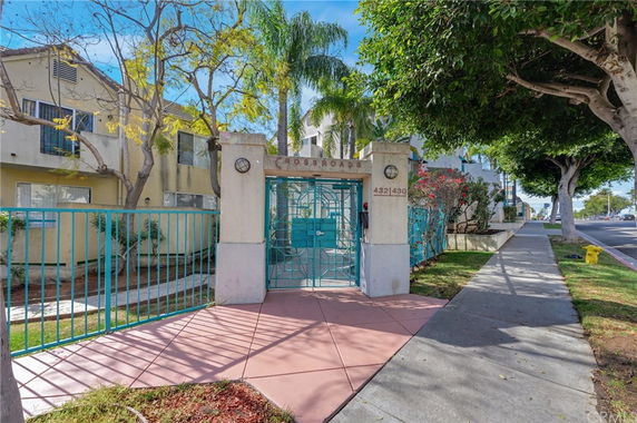 Front view of a gated residential apartment complex entrance.