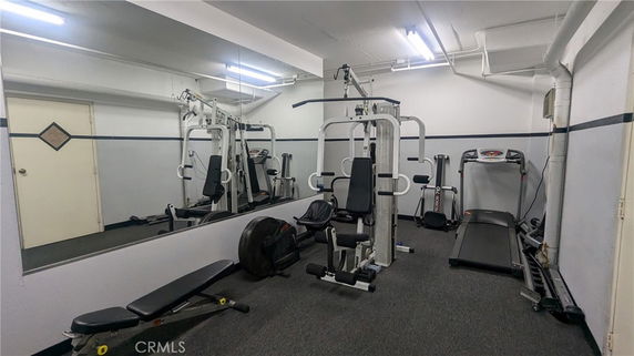 Indoor gym area with various exercise equipment.