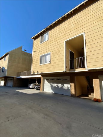 Front view of a multi-story building with garages.