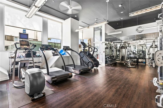 Indoor gym area with various exercise equipment including treadmills and weight machines.