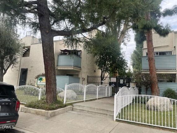 Front view of a multi-story residential building with balconies.