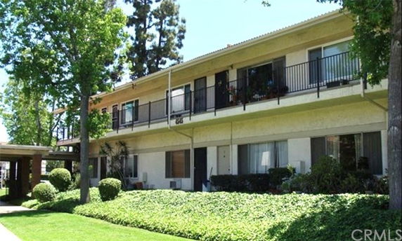 Front view of a two-story apartment building with balconies.