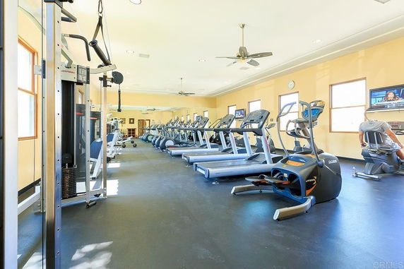 Interior view of a gym with exercise equipment and treadmills.