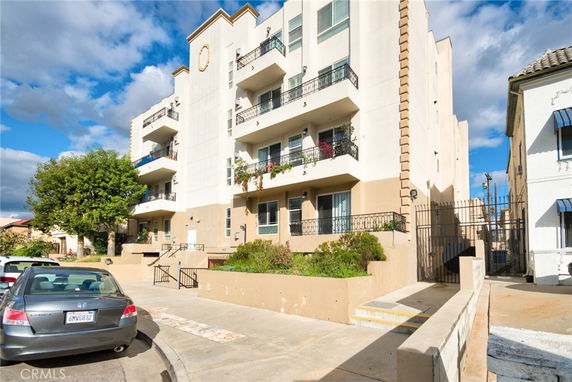 Front view of a multi-story building with balconies.