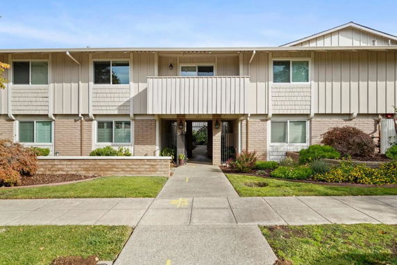 Front view of a two-story residential building with a central entrance.