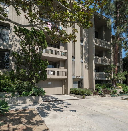 Front view of a multi-story apartment building with balconies.