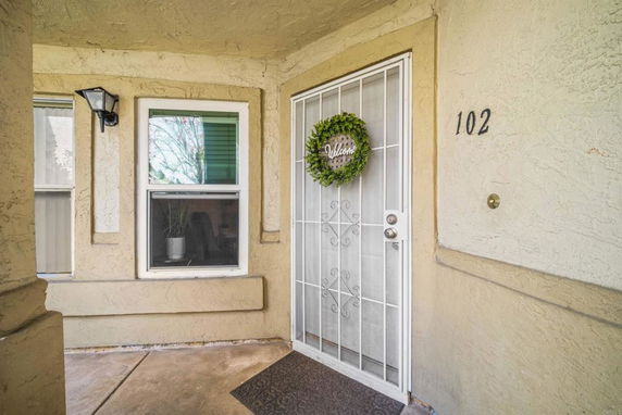 Front entrance of a house with a security door and decorative wreath.