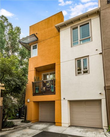 Front view of a modern multi-story house with two garages.