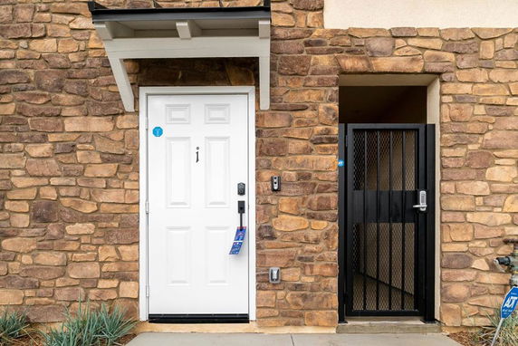 Front view of a building with a stone exterior and a white door.