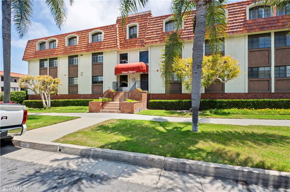 Front view of a multi-story building with a red canopy entrance.