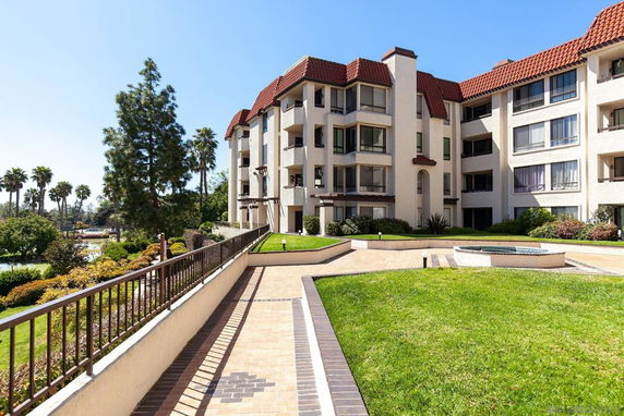 Front view of a multi-story residential building with red tile roofing.