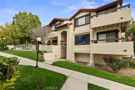 Front view of a multi-story residential building with balconies.