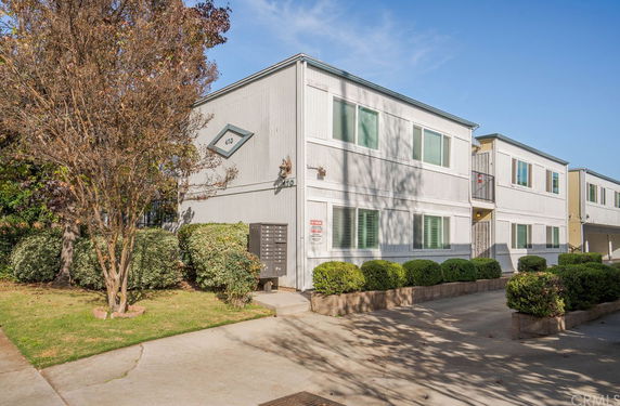 Front view of a two-story apartment building with multiple windows.