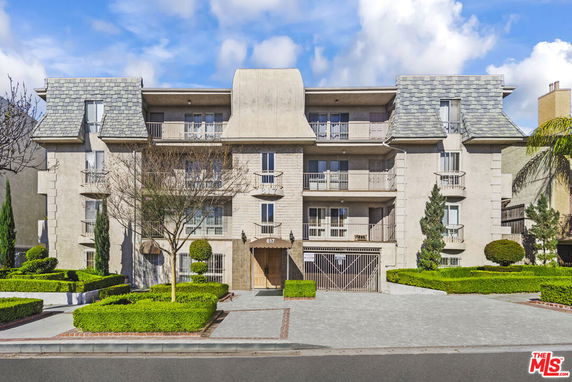 Front view of a multi-story residential building with balconies.