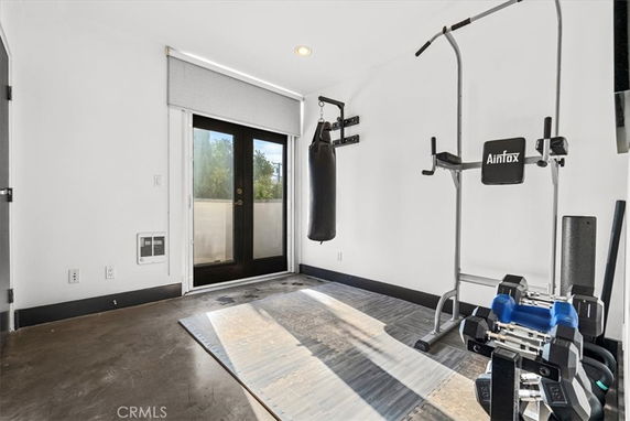 Room with gym equipment including a punching bag and weights