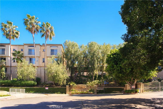 Front view of a multi-story residential building with balconies.