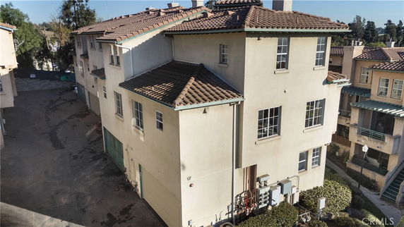 Front view of a multi-story residential building with a tiled roof.