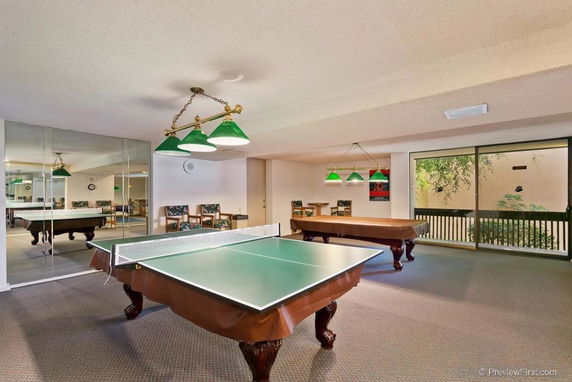 Indoor recreation area with table tennis and billiard tables.
