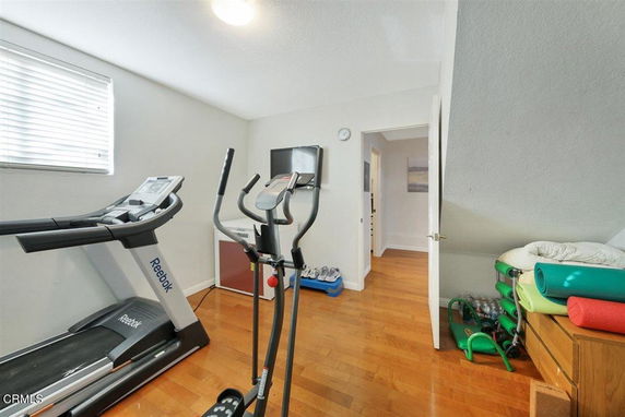 Indoor room with exercise equipment and yoga mats.
