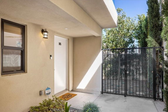 Front view of a building entrance with a door numbered 105 and a metal gate.