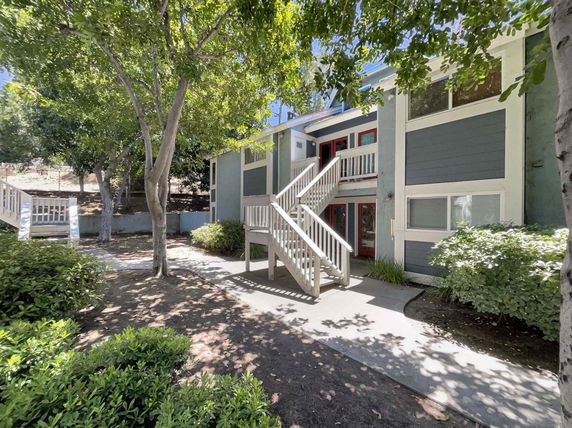 Front view of a two-story building with a staircase leading to the upper level.