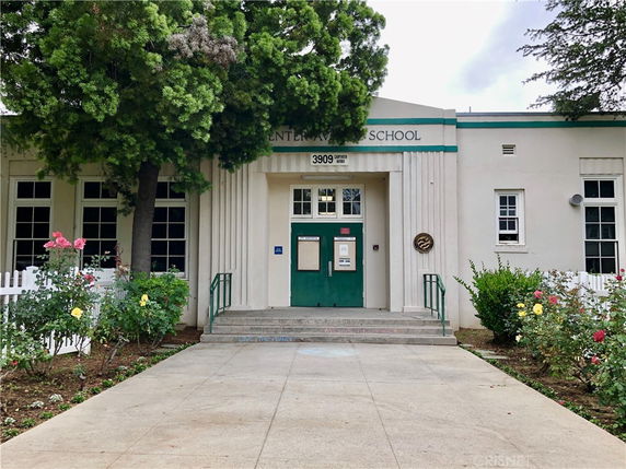 Front view of a school building with a central entrance.