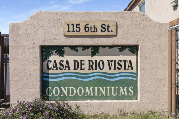 Front view of an entrance sign for Casa de Rio Vista Condominiums.