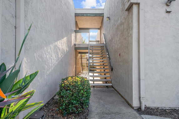 View of a building's exterior with a stairway leading to an upper level.